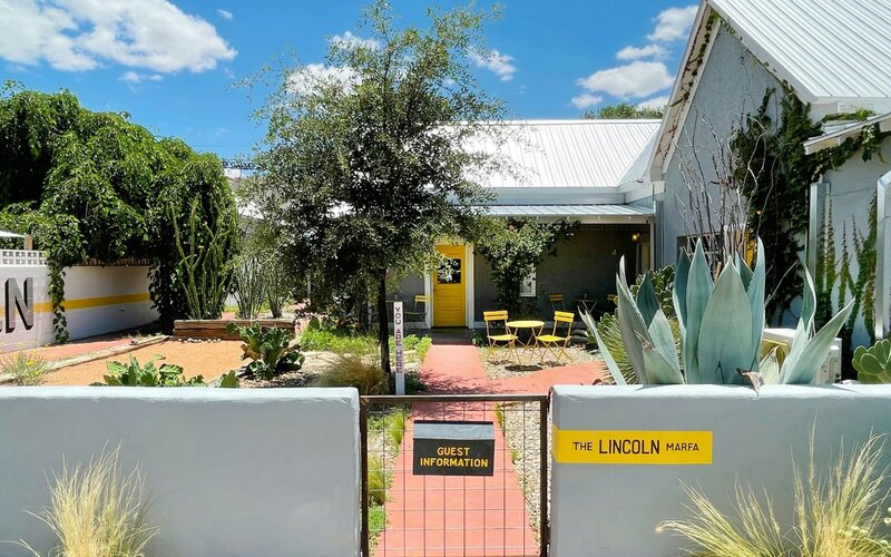 The gated courtyard and yellow door at The Lincoln Marfa