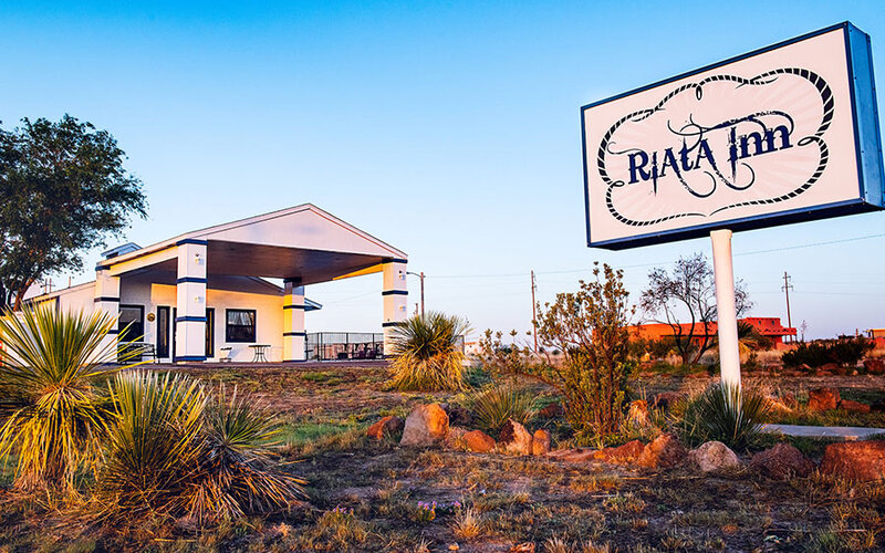 The Riata Inn sign and entrance east of town