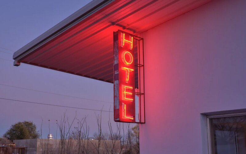 The neon HOTEL sign at the Thunderbird at dusk